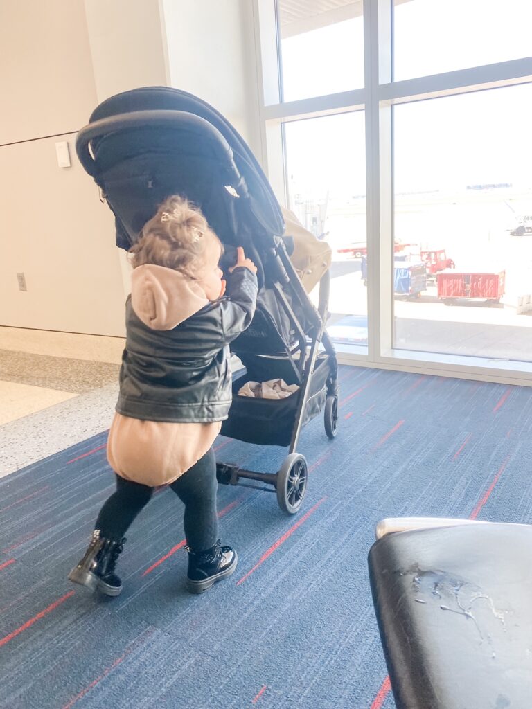 toddler pushing her inglesina quid travel stroller
